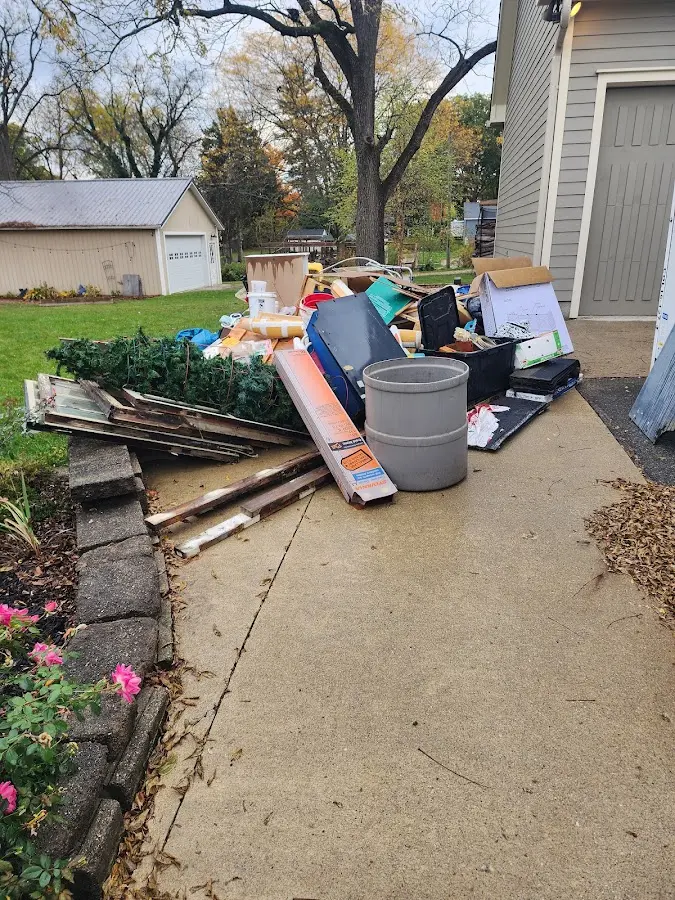 Dumpster being loaded with debris for 12 Yard Dumpster Rental in Radnor